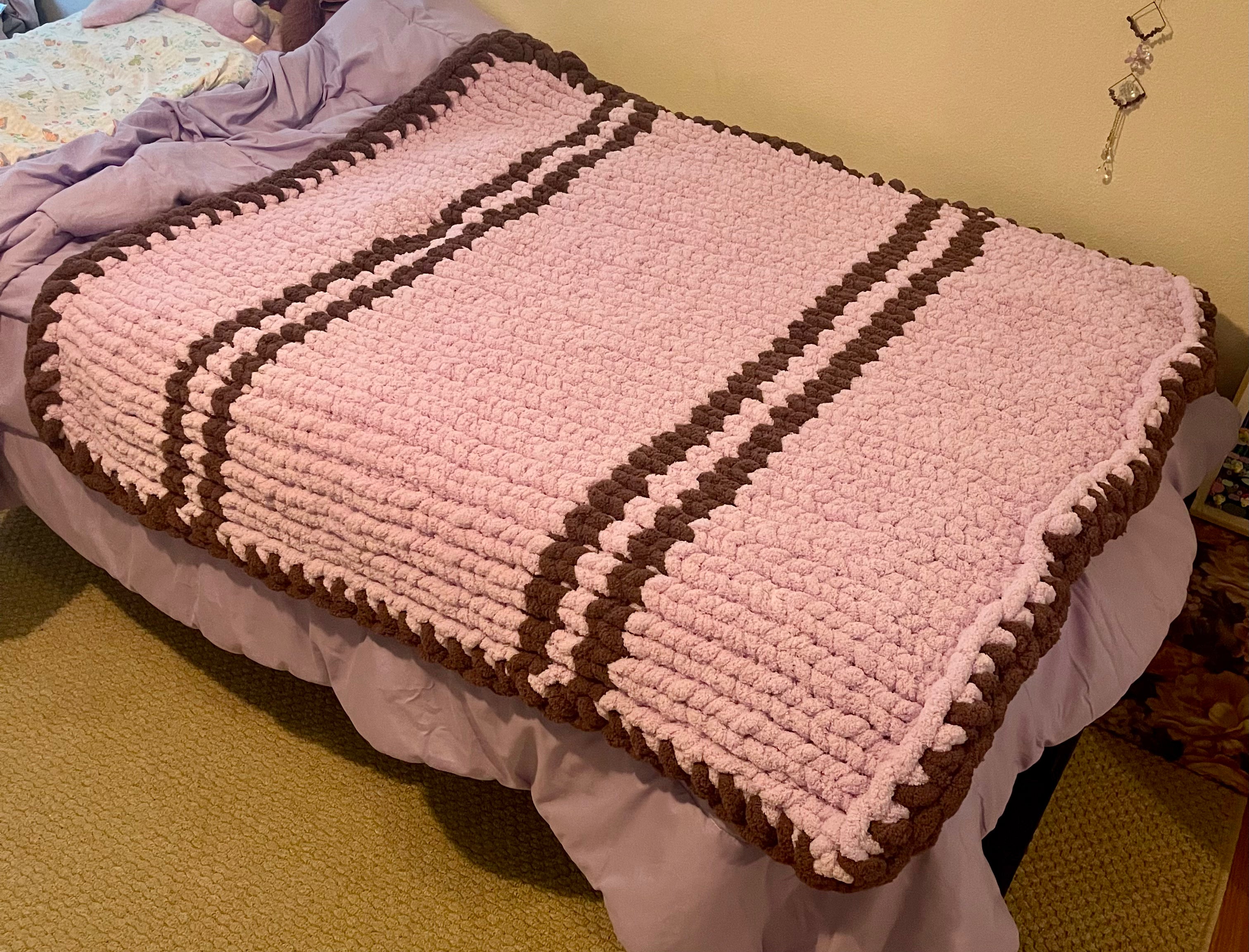 This blanket is a throw size knit stitch with Orchid as the main color and French Lilac as the border and stripes.